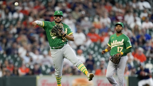 Oakland Athletics third baseman Vimael Machin throws out Houston Astros' Jose Altuve for the final out during a game.