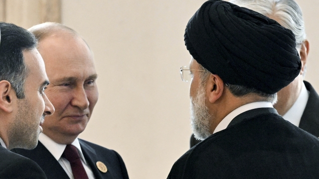 Russian President Vladimir Putin speaks to Iranian President Ebrahim Raisi