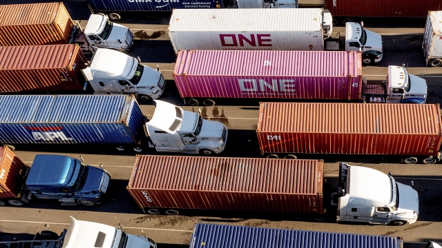 Trucks line up to enter a Port of Oakland shipping terminal on Nov. 10, 2021, in Oakland, Calif.