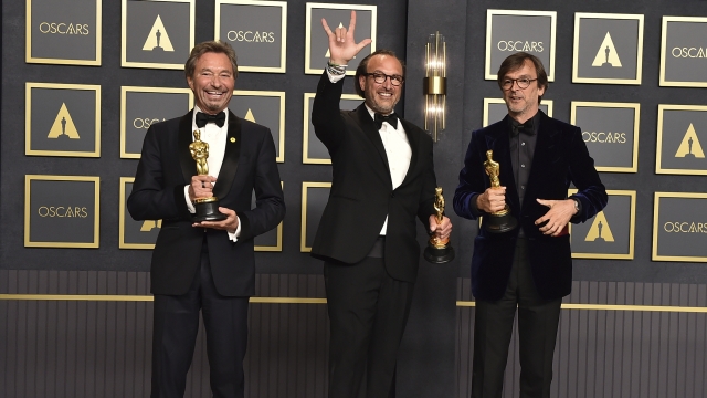 From left, Patrick Wachsberger, Fabrice Gianfermi, and Philippe Rousselet, winners of the award for best picture for "CODA."