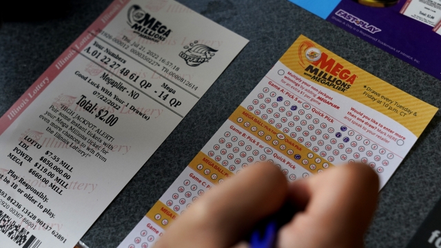 A customer fills out a Mega Millions lottery ticket.