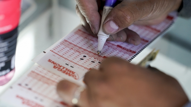 Manuel R. Martínez selects numbers to play before buying Mega Millions lottery tickets