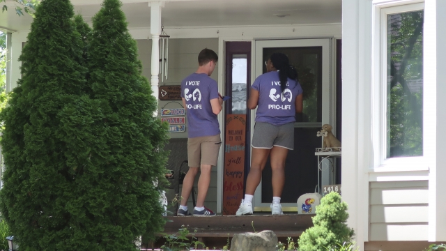 Canvassers speak with prospective voters in Kansas