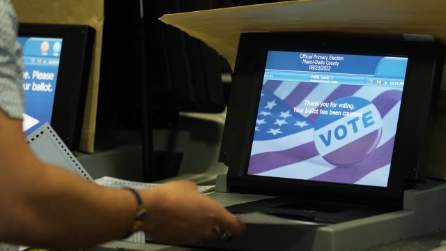 An elections employee tests voting equipment.