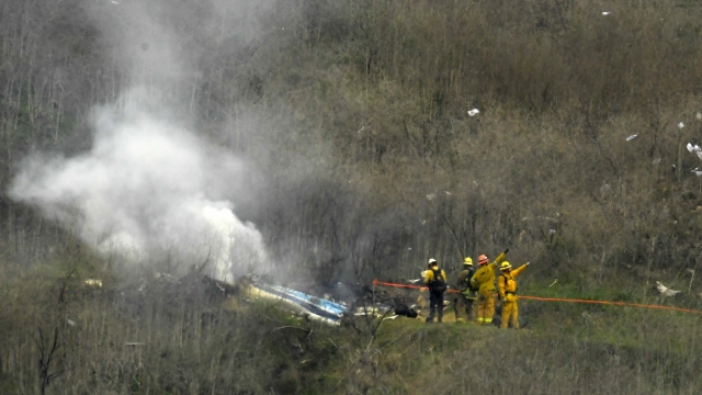 Firefighters work the scene of a helicopter crash where former NBA basketball star Kobe Bryant died in Calabasas, Calif.