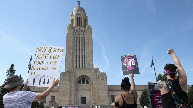 Protesters line the street around the front of the Nebraska State Capitol.