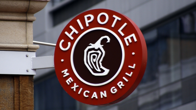 A Chipotle sign hangs outside the chain restaurant