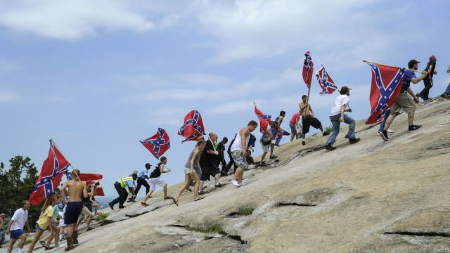A group carries Confederate flags