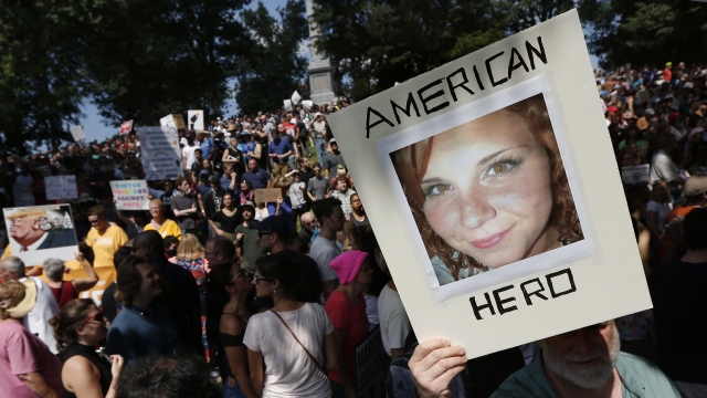 a protester holds a photo of Heather Heyer on Boston Common