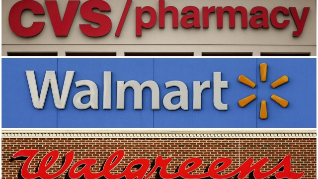 A combination of file photos show the signs of CVS, Walmart and Walgreens.