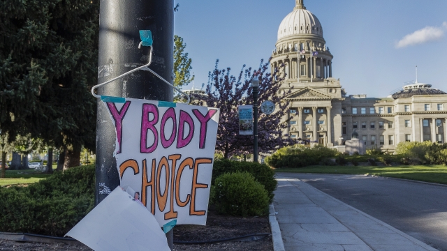 A sign reading "My Body, My Choice" is ripped outside the Idaho State Capitol Building