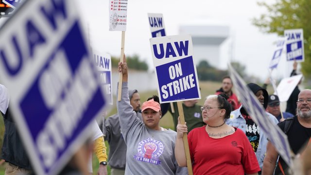 Members of the United Auto Workers strike outside of a John Deere plant.