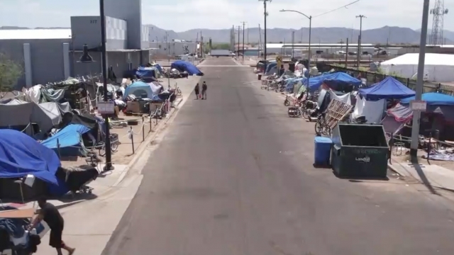 A homeless encampment in Phoenix is shown.