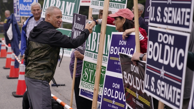 New Hampshire Republican U.S. Senate candidate Don Bolduc, shakes hands with campaign volunteers after voting