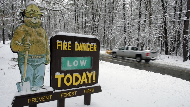 A sign, featuring a likeness of Smokey Bear, at the entrance to Hopkinton State Park Headquarters