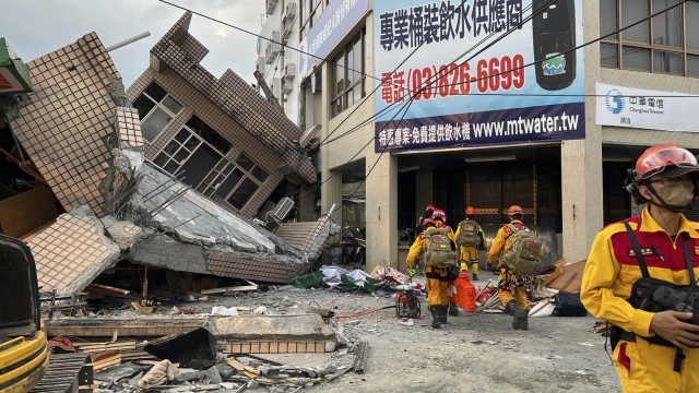 Firefighters in the search for trapped victims in a collapsed residential building following earthquake in Yuli, Taiwan.