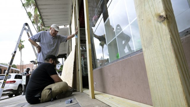 People board up a business in Florida