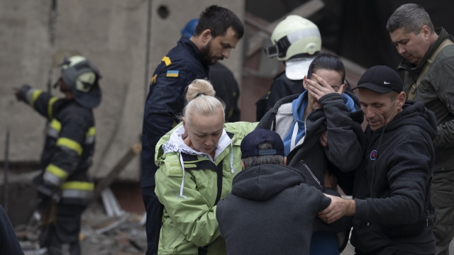 Woman crying after Ukrainian rescue workers found a body.