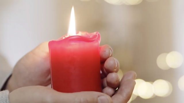 A person holding a candle