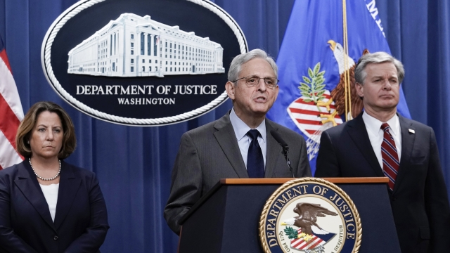Attorney General Merrick Garland, center, flanked by Deputy Attorney General Lisa Monaco and FBI Director Christopher Wray