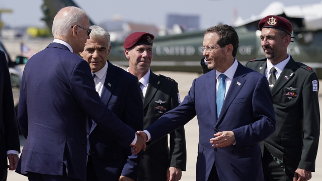 U.S. President Joe Biden shakes hands with Israel's President Isaac Herzog.
