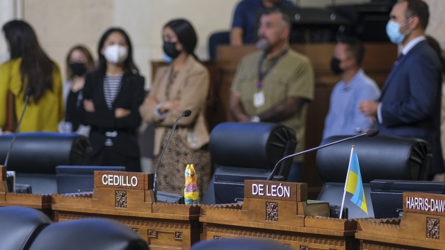 Empty seats of Angeles City Council members Gil Cedillo and Kevin de Leon are seen in the chamber