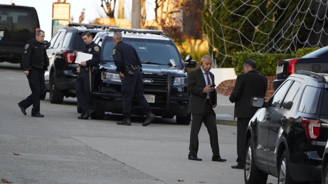 Police investigators work outside the home of House Speaker Nancy Pelosi.