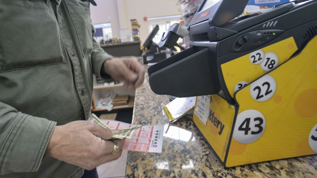A store manager prints out Powerball tickets