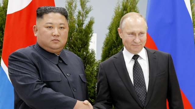 Russian President Vladimir Putin, right, and North Korea's leader Kim Jong Un shake hands