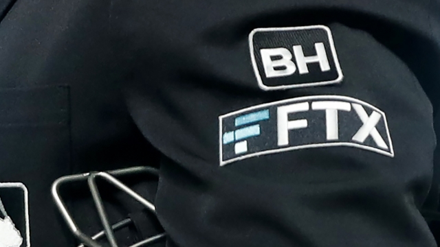 The FTX logo on a baseball umpire's jacket.