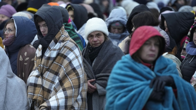 Refugees fleeing Ukraine arrive at a Poland border crossing.