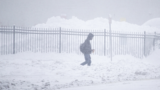 A person walks through downtown in the snow in Buffalo, N.Y.