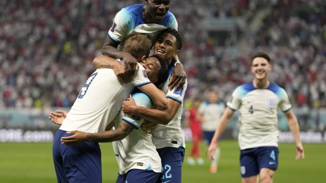 England's Raheem Sterling celebrates with teammates after scoring his side's third goal.