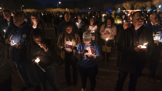 Community members, including Walmart employees, gather for a candlelight vigil at Chesapeake City Park in Virginia.