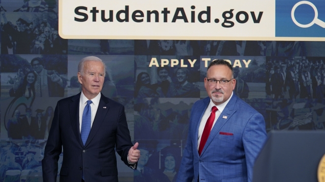 President Joe Biden with Education Secretary Miguel Cardona.