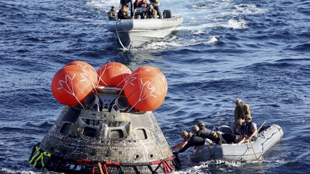 U.S. Navy divers secure NASA's Orion capsule during recovery operations.