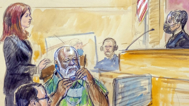 An artist's rendering of Whitney Minter standing as she represents Abu Agela Mohammad Mas'ud Kheir Al-Marimi in court.