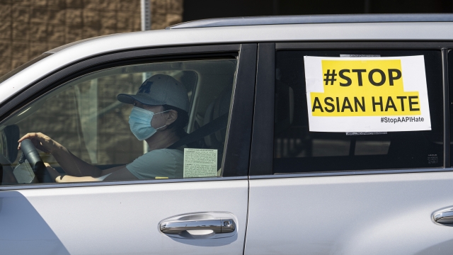 A "#StopAsianHate" sign hangs on a car window.