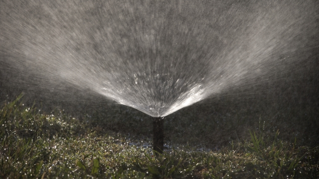 A sprinkler waters a lawn.