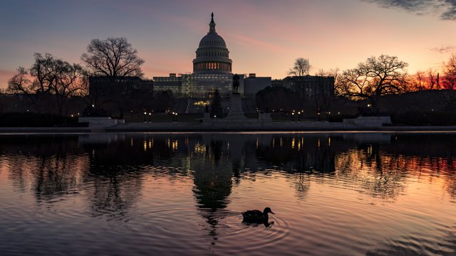 The sun rises behind the Capitol in Washington.