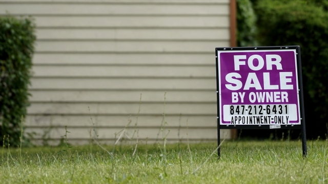 A sign is displayed in front of a home for sale in Prospect Heights, Ill.