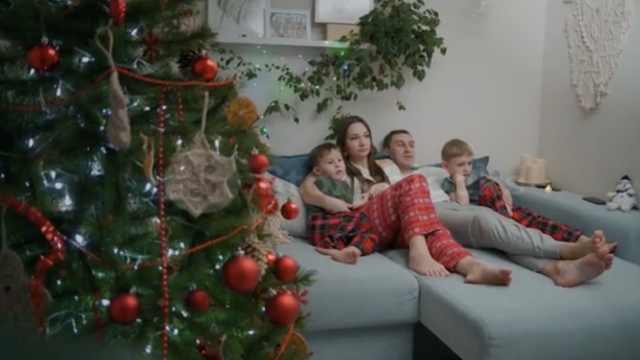 A family watches a movie during Christmas time.