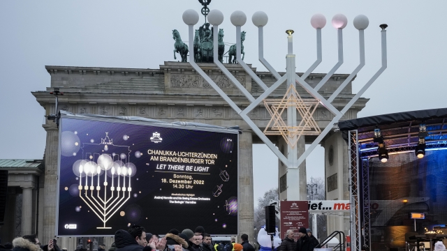 People attend the official lighting of a giant Hanukkah Menorah, set up by the Jewish Chabad Educational Center