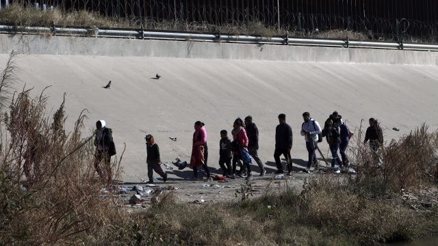 Migrants walk near the U.S.-Mexico border in Ciudad Juarez, Mexico