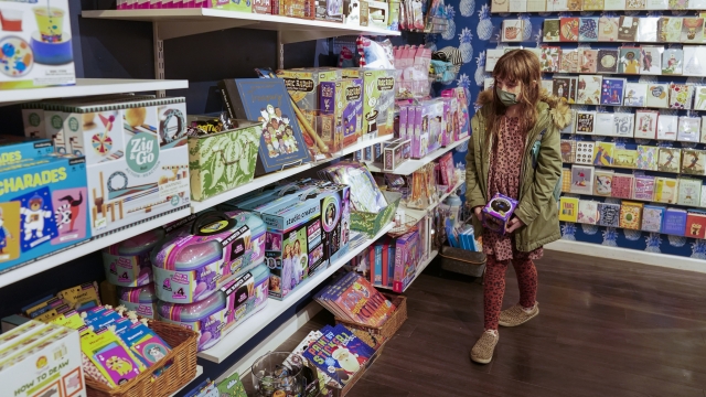 Girl browses toys at a store.