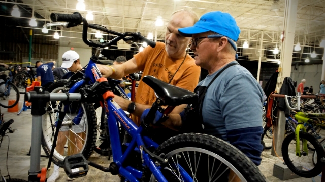 Volunteers at Bike Alpharetta repairing a bike