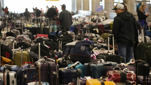 Travelers wade through fields of unclaimed luggage by the baggage casrousels for Southwest Airlines in Denver