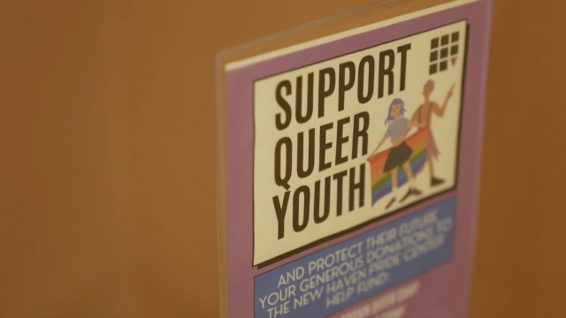 A sign says "Support Queer Youth"