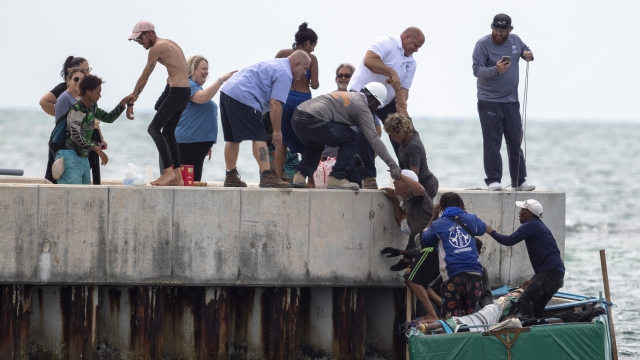 Residents help Cuban migrants to shore near Key West, Fla.