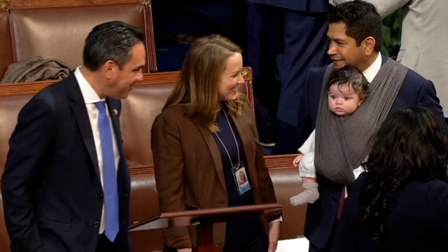 Representative Jimmy Gomez wore his 4-month-old son Hodge as he waits to be sworn in.